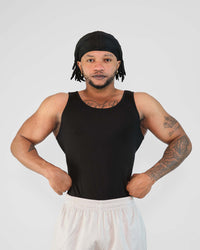 Model wearing a tight-fitting black bamboo viscose tank top, showcasing breathability and comfort for workouts.