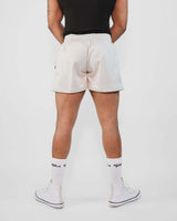Rear view of a model wearing 3-inch mesh shorts, showcasing the breathable design and slim fit.