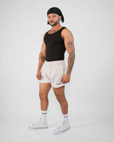 Model wearing 3-inch mesh shorts and tank top, showcasing breathable polyester material and zippered pockets.